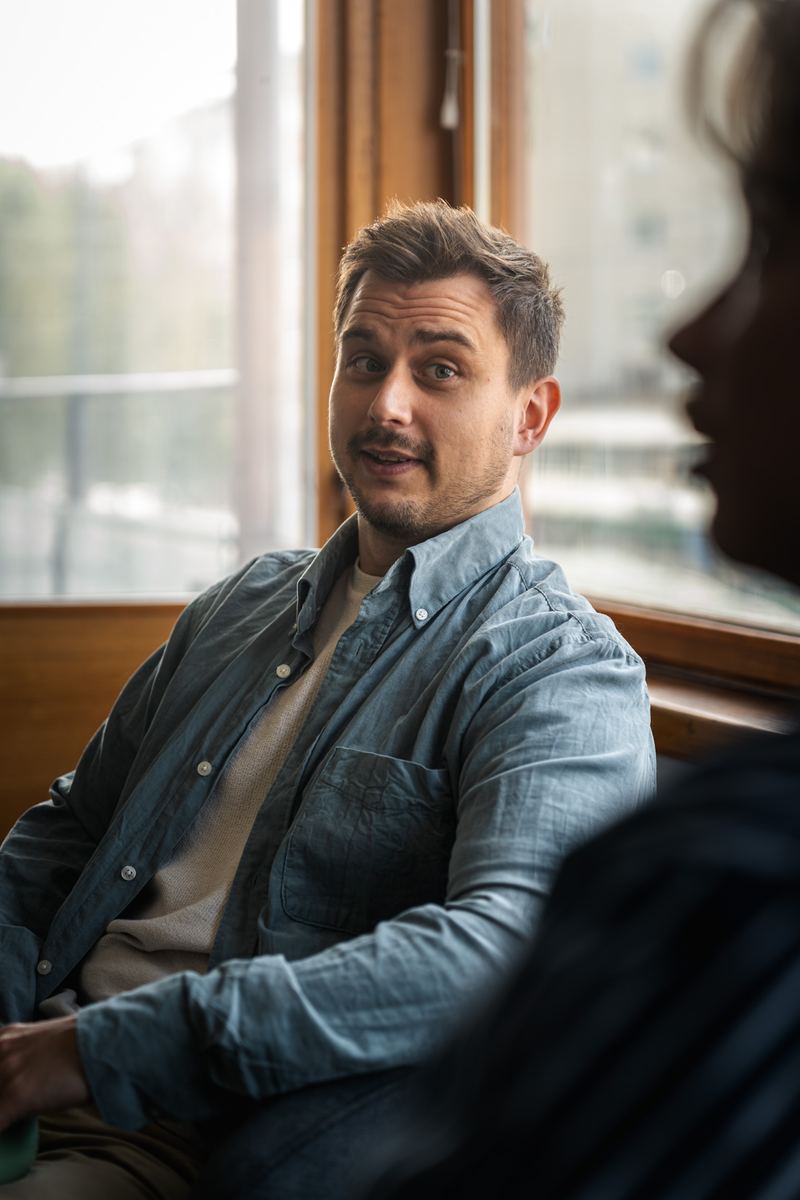 A WebAula team member talking by the window